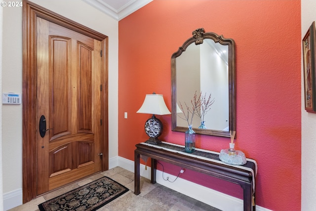 foyer entrance featuring baseboards and ornamental molding