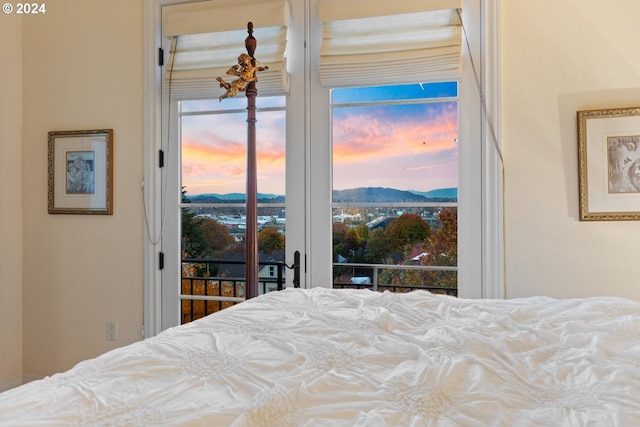 bedroom with a mountain view and access to exterior