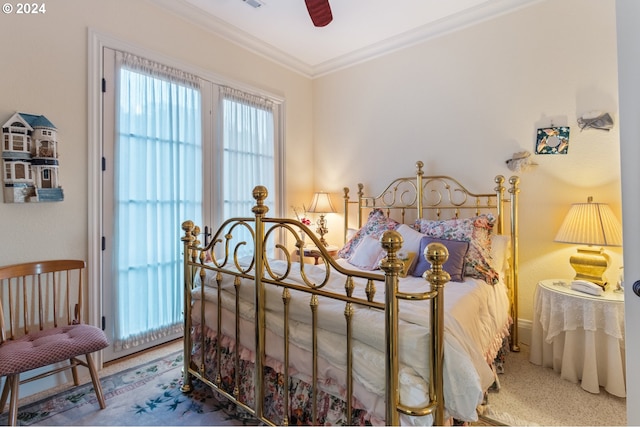 carpeted bedroom featuring ornamental molding and ceiling fan