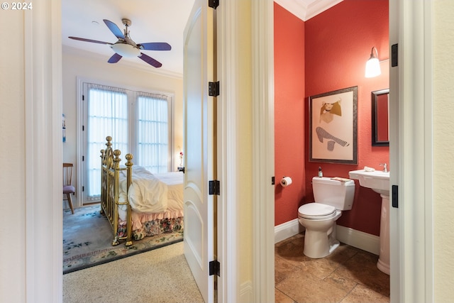 half bathroom featuring ornamental molding, baseboards, toilet, and a ceiling fan