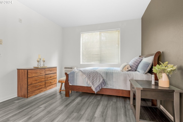 bedroom featuring wood finished floors and baseboards