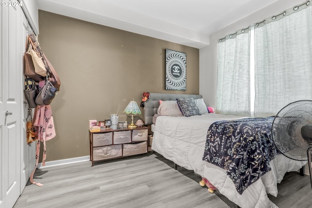 bedroom with wood finished floors and baseboards