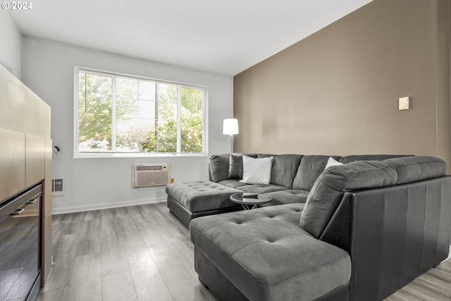 living room with light wood-type flooring, vaulted ceiling, and an AC wall unit