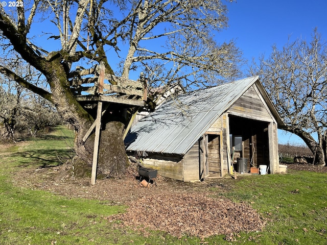 view of property exterior with cooling unit and an outdoor structure