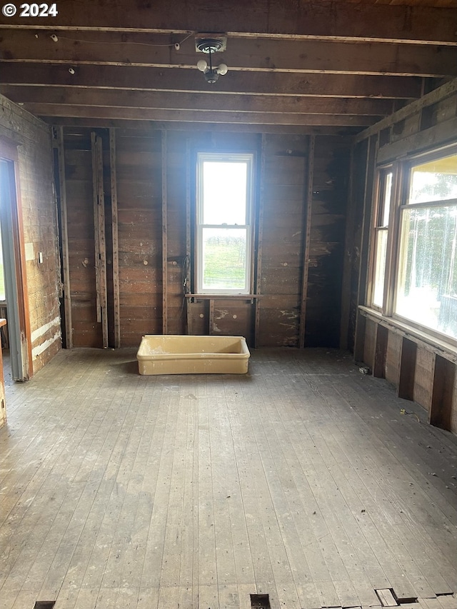 misc room with hardwood / wood-style flooring and wood walls