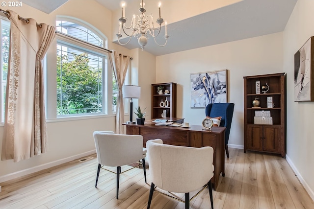 home office featuring light wood finished floors, baseboards, visible vents, and a chandelier