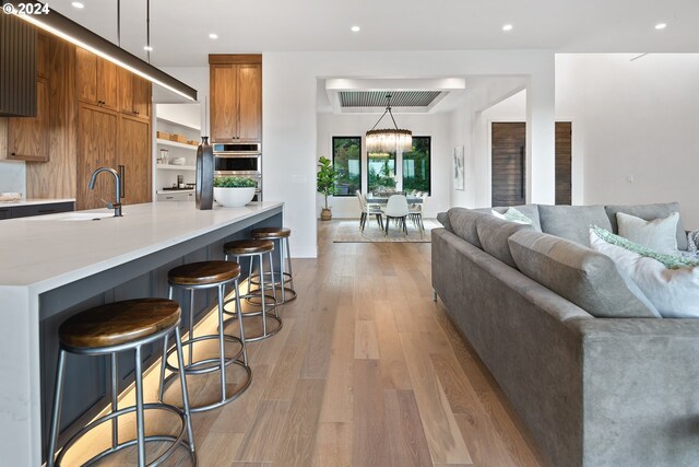 bar featuring white cabinetry and light hardwood / wood-style floors