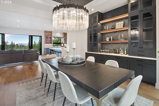 dining room featuring a chandelier and light wood-type flooring