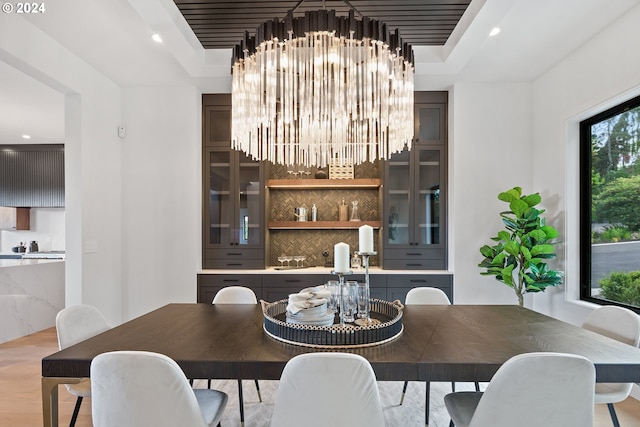 dining space featuring a notable chandelier and light wood-type flooring