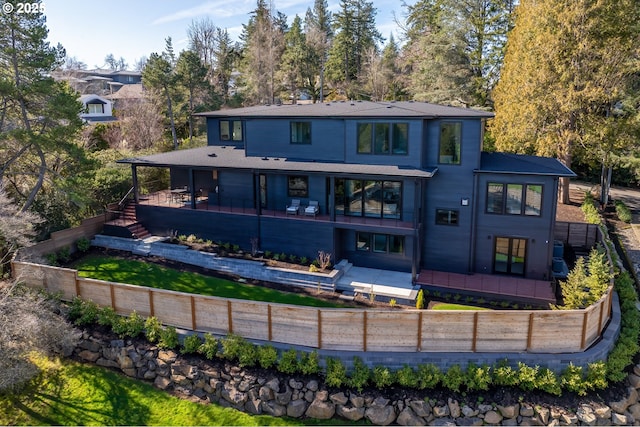 rear view of house with a patio and a fenced backyard