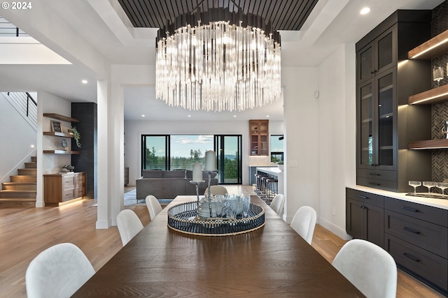dining space featuring light wood-type flooring, stairs, baseboards, and recessed lighting
