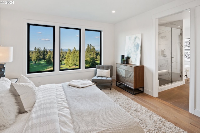 bedroom with baseboards, wood finished floors, and recessed lighting