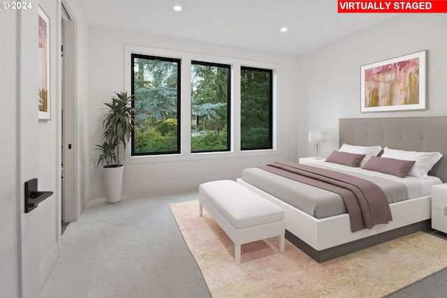 bedroom with recessed lighting, light colored carpet, and baseboards