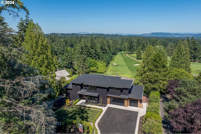 birds eye view of property with a wooded view