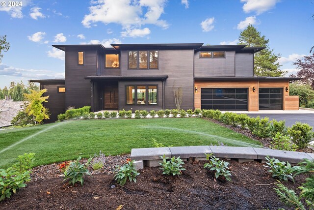 view of front facade with a front yard and a garage