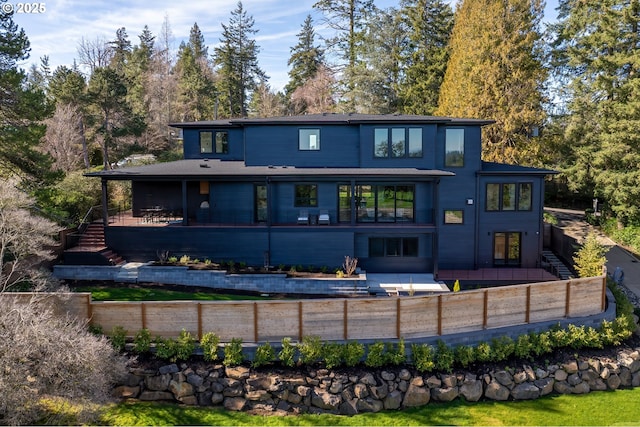 rear view of house with stairs, a patio area, and fence private yard