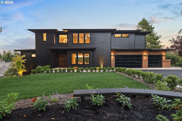 view of front facade featuring aphalt driveway, a front lawn, and an attached garage