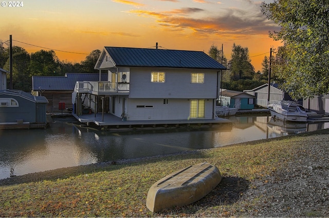 back house at dusk featuring a yard