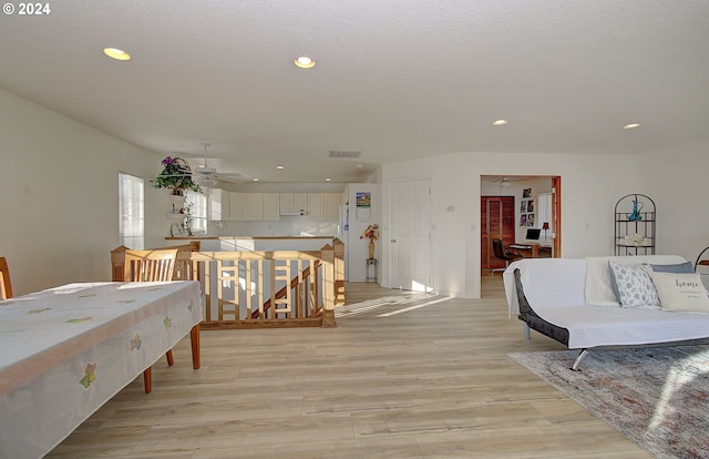 dining room with ceiling fan and light hardwood / wood-style flooring