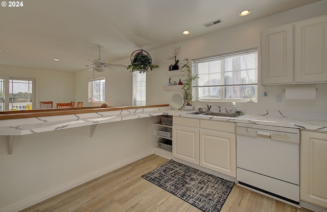 kitchen featuring kitchen peninsula, light hardwood / wood-style floors, and dishwasher