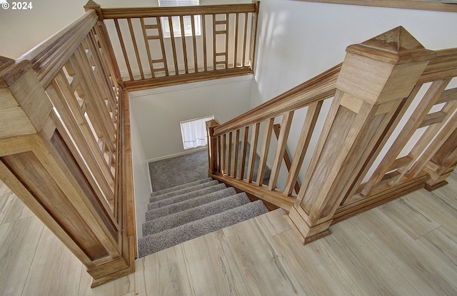 staircase with wood-type flooring and a wealth of natural light