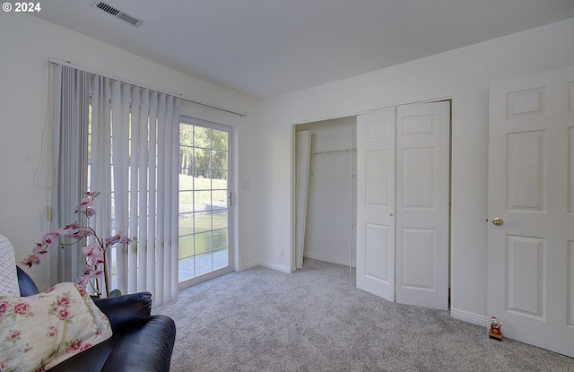 living area with light colored carpet