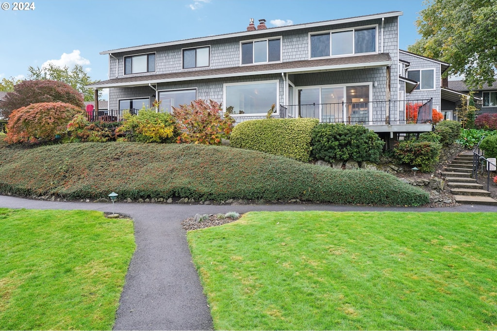 view of front property with a front lawn and a deck