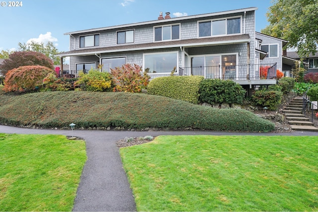 view of front property with a front lawn and a deck