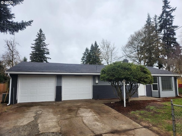 view of front of home with central AC unit and fence