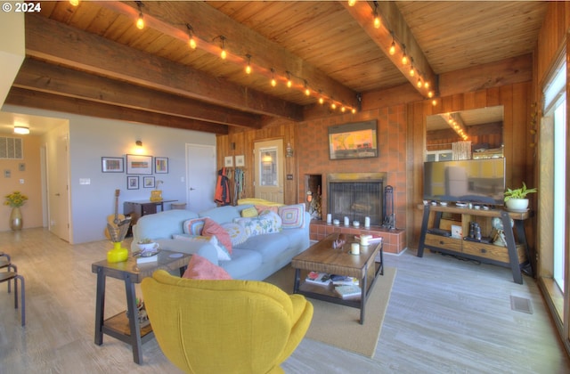 living room with beam ceiling, wooden ceiling, light hardwood / wood-style flooring, and wooden walls