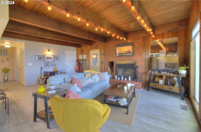 29134 Ellensburg Ave Unit 2, Gold Beach, OR 97444 - living room featuring track lighting, wooden ceiling with exposed beams, wood finished floors, and a fireplace with raised hearth