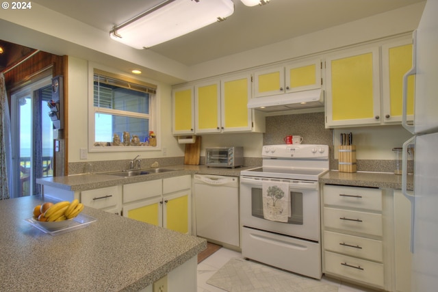 29134 Ellensburg Ave Unit 2, Gold Beach, OR 97444 - kitchen featuring white appliances, under cabinet range hood, a sink, white cabinetry, and light tile patterned flooring
