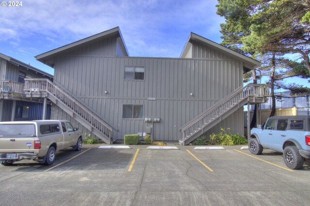 29134 Ellensburg Ave Unit 2, Gold Beach, OR 97444 - view of property featuring stairway and uncovered parking