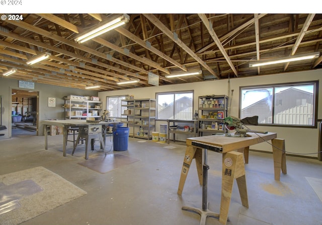 dining space featuring a workshop area, plenty of natural light, and concrete floors