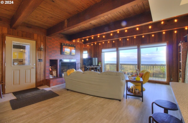 29134 Ellensburg Ave Unit 2, Gold Beach, OR 97444 - living area with wood ceiling with exposed beams, wood finished floors, and a fireplace