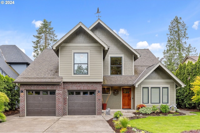 view of front of house featuring a garage and a front lawn