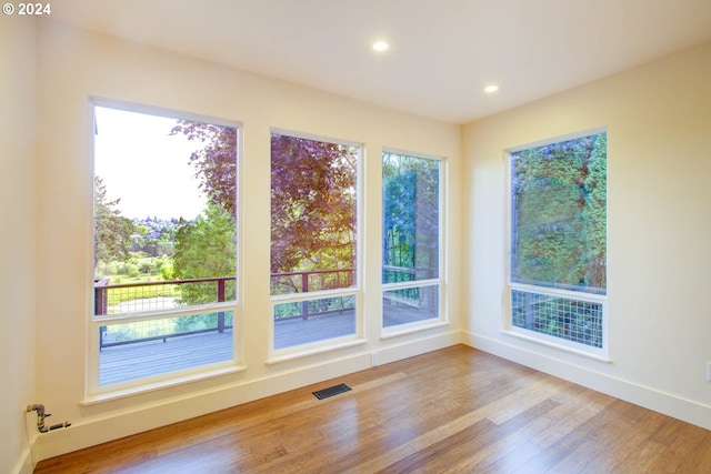 empty room with hardwood / wood-style flooring