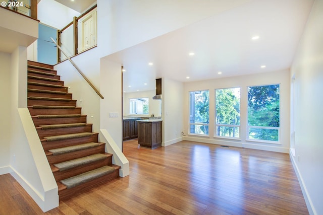 staircase with wood-type flooring