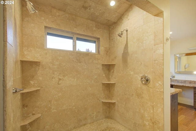 bathroom with vanity and a tile shower