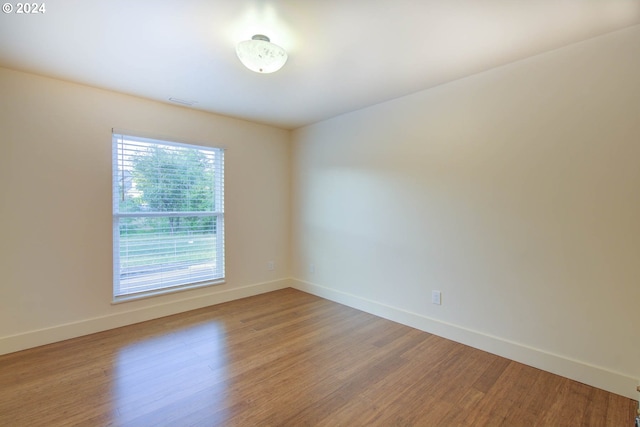 unfurnished room with hardwood / wood-style floors