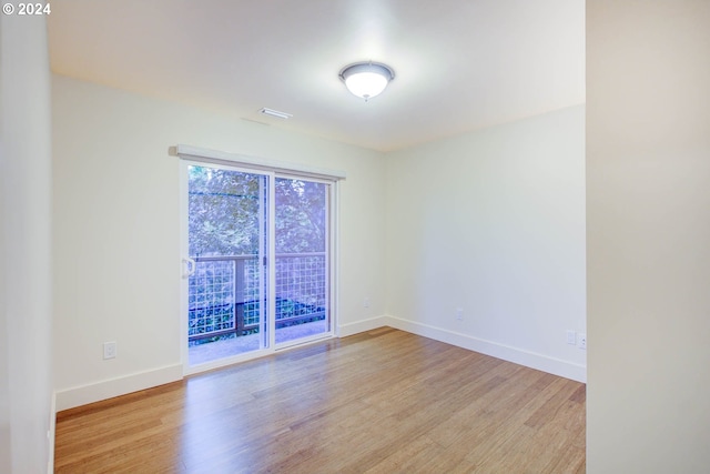 spare room with light hardwood / wood-style flooring