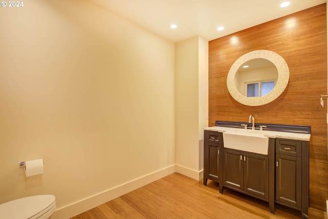 bathroom featuring vanity, toilet, and wood-type flooring