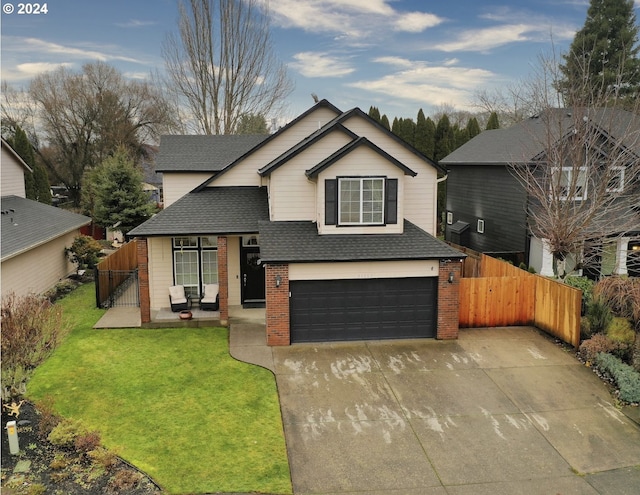 view of front of property featuring a front lawn and a garage