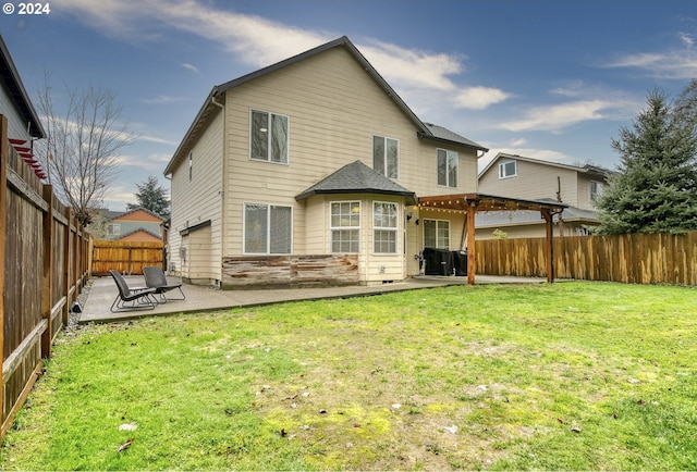 back of property featuring a lawn and a patio area