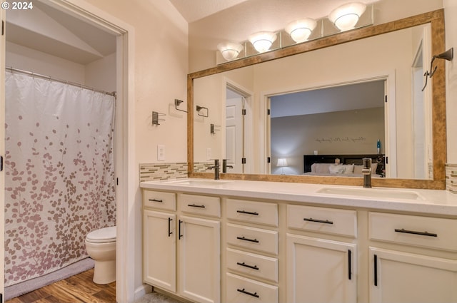 bathroom with hardwood / wood-style floors, vanity, toilet, and a shower with curtain