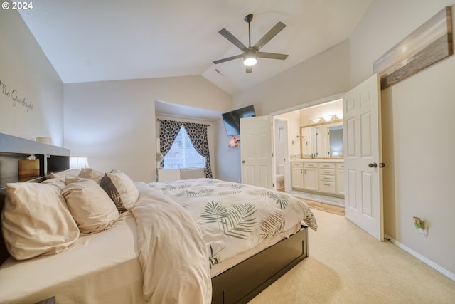 carpeted bedroom featuring ensuite bath, vaulted ceiling, and ceiling fan