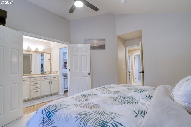 bedroom featuring ceiling fan, light wood-type flooring, lofted ceiling, and ensuite bath