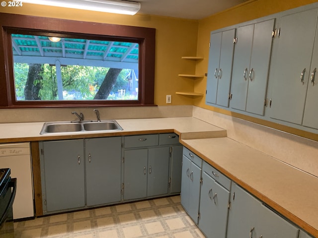 kitchen featuring dishwasher, gray cabinets, and sink