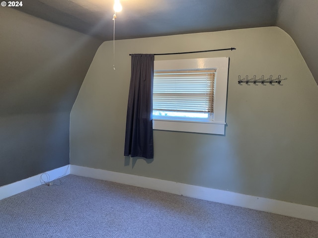 bonus room with carpet flooring and lofted ceiling