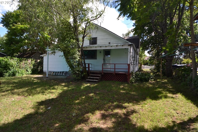 rear view of house with a yard